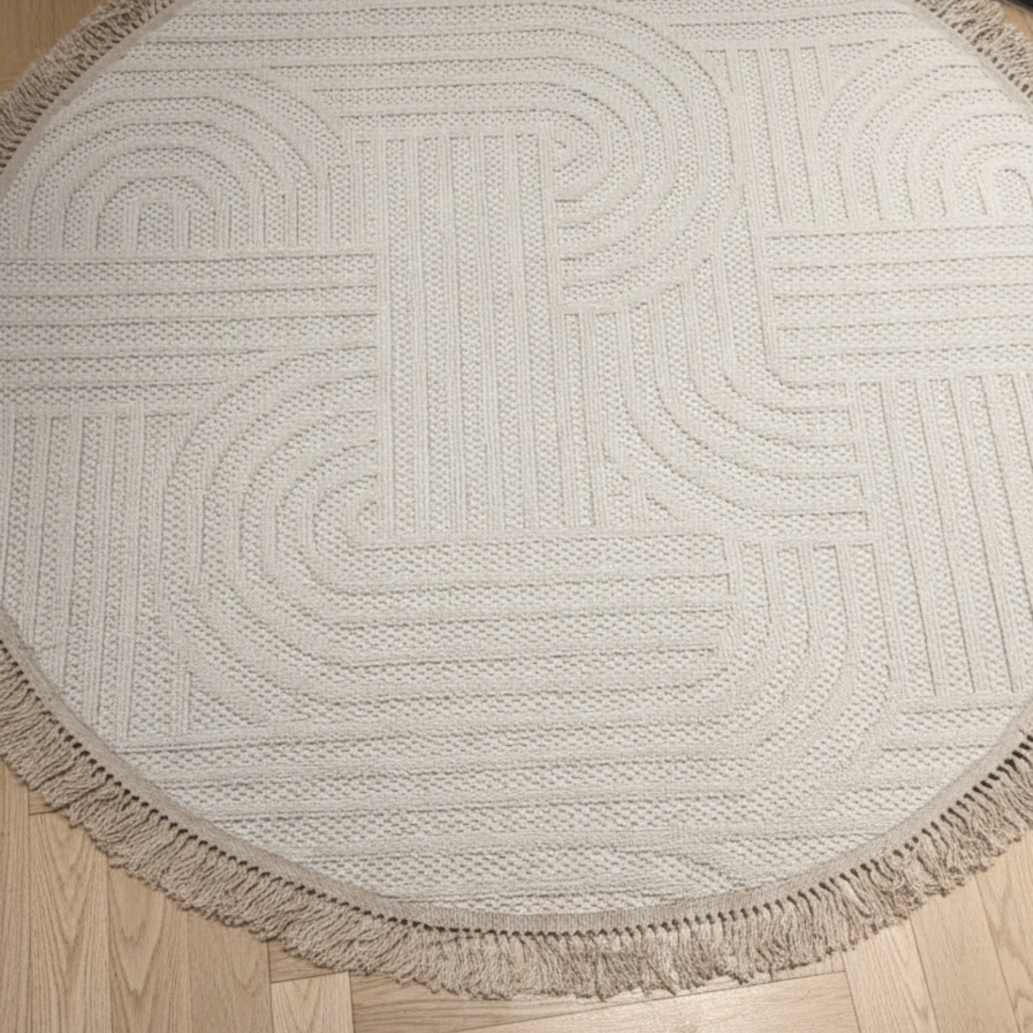 Round beige rug with a geometric pattern on a wooden floor