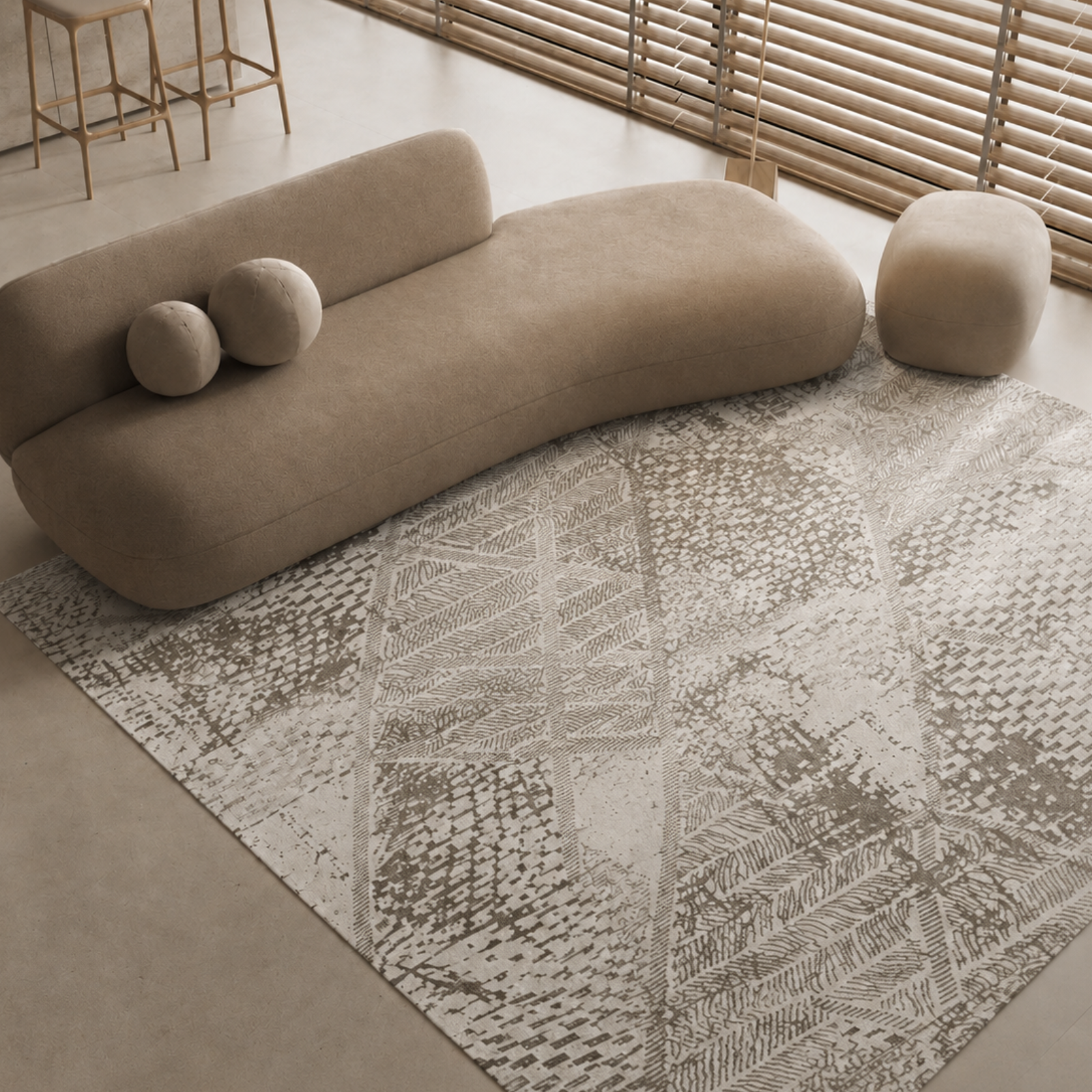 Beige sofa with spherical cushions on a patterned rug in a modern room.